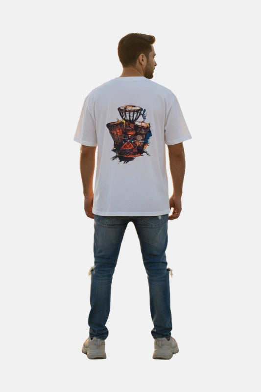 Man wearing a white t-shirt with a colorful design on the back, standing against a plain background. Graphic White Drop Shoulder "Dhool" T-Shirt Royal Outfits Drop Shoulder T-Shirts - Graphic White Drop Shoulder "Dhool" T-Shirt - Royal Outfits - Drop Shoulder T-Shirts