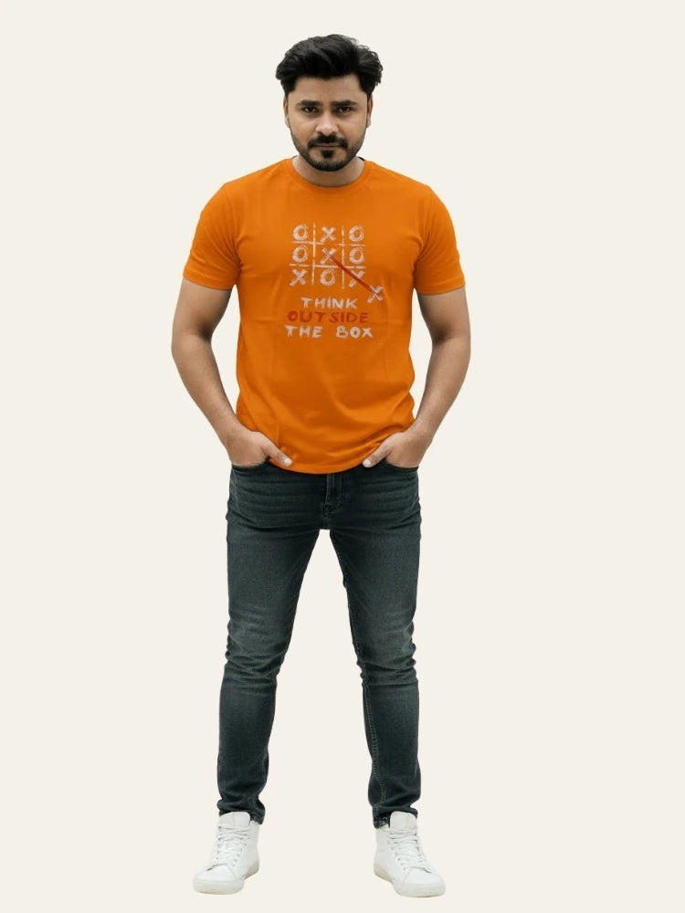 Man wearing an orange t-shirt with text design on a plain background Graphic Orange Crossword T-Shirt Royal Outfits Graphic T Shirts