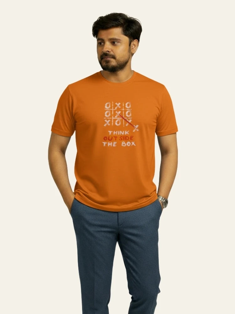 Man wearing an orange t-shirt with text and design on a plain background Graphic Orange Crossword T-Shirt Royal Outfits Graphic T Shirts