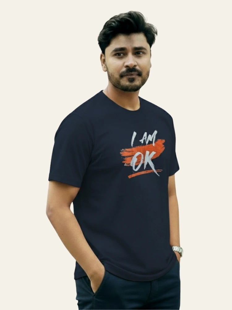 Man wearing a navy blue t-shirt with 'I AM OK' text on a plain background Graphic Navy Blue "I'M OK" T-Shirt Royal Outfits Graphic T Shirts