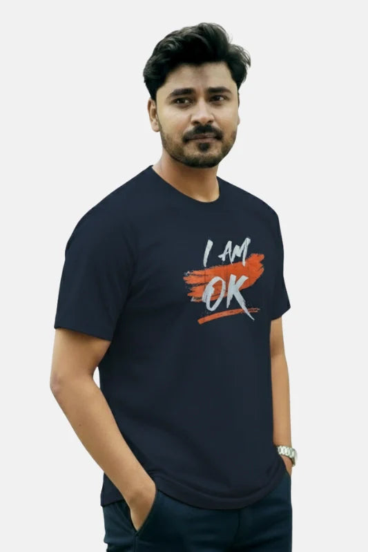 Man wearing a navy blue t-shirt with 'I AM OK' text on a plain background Graphic Navy Blue "I'M OK" T-Shirt Royal Outfits Graphic T Shirts - Graphic Navy Blue "I'M OK" T-Shirt - Royal Outfits - Graphic T Shirts - Graphic Navy Blue "I'M OK" T-Shirt - Royal Outfits