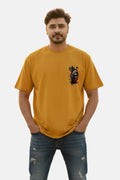 Man wearing a mustard yellow t-shirt with a graphic design on a plain background Graphic Mustard/Yellow Drop Shoulder Axe Man T-Shirt Royal Outfits Drop Shoulder T-Shirts - Graphic Mustard/Yellow Drop Shoulder Axe Man T-Shirt - Royal Outfits - Drop Shoulder T-Shirts