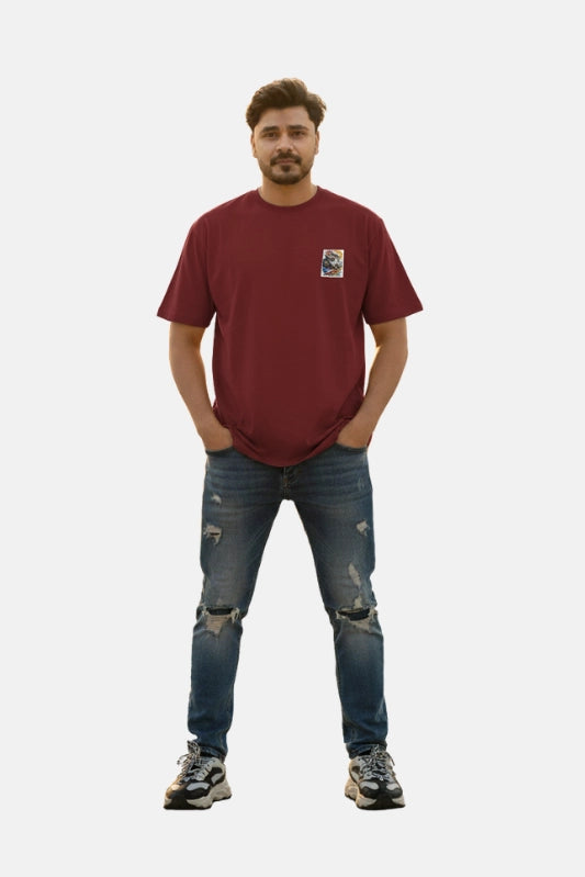 Man wearing a red t-shirt and blue jeans on a plain background Graphic Maroon Drop Shoulder King Ace T-Shirt Royal Outfits Drop Shoulder T-Shirts - Graphic Maroon Drop Shoulder King Ace T-Shirt - Royal Outfits - Drop Shoulder T-Shirts