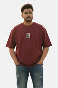 Man wearing a maroon t-shirt with a small graphic on a plain background Graphic Maroon Drop Shoulder King Ace T-Shirt Royal Outfits Drop Shoulder T-Shirts
