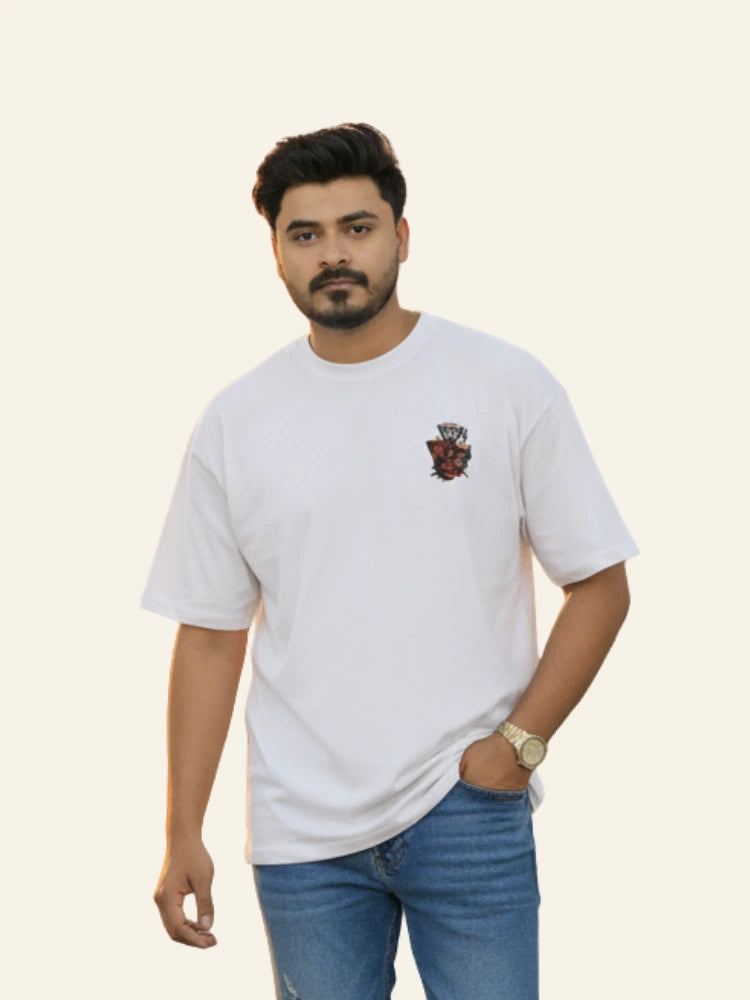 Man wearing a white t-shirt with a logo on a beige background Graphic White Drop Shoulder "Dhool" T-Shirt Royal Outfits Drop Shoulder T-Shirts