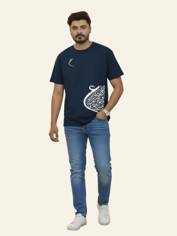 Man wearing a navy blue t-shirt with a white graphic design and blue jeans on a beige background Graphic Navy Blue Drop Shoulder Calligraphy T-Shirt Royal Outfits Drop Shoulder T-Shirts