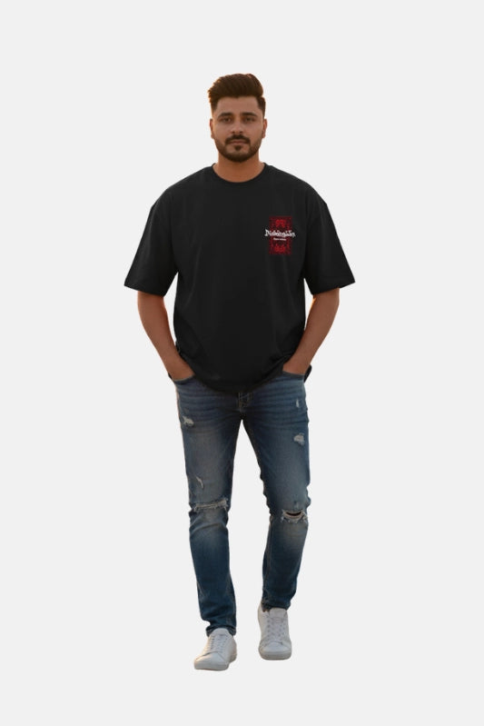 Man wearing a black t-shirt with a red logo and blue jeans on a white background Graphic Black Drop Shoulder Dimension T-Shirt Royal Outfits Drop Shoulder T-Shirts - Graphic Black Drop Shoulder Dimension T-Shirt - Royal Outfits - Drop Shoulder T-Shirts
