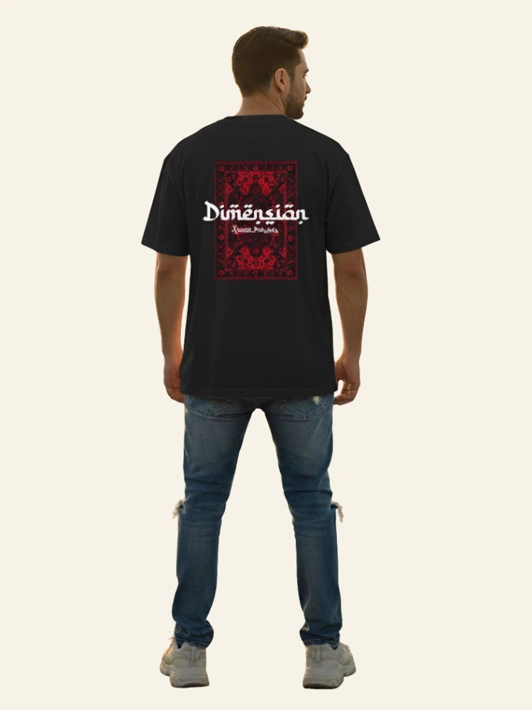 Man wearing a black t-shirt with a red and white graphic design on the back, standing against a plain background. Graphic Black Drop Shoulder Dimension T-Shirt Royal Outfits Drop Shoulder T-Shirts