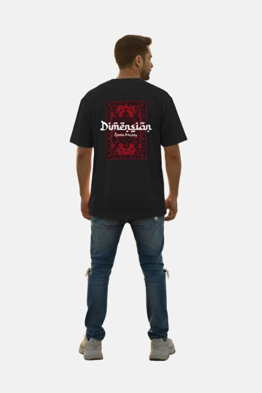Man wearing a black t-shirt with a red and white graphic design on the back, standing against a plain background. Graphic Black Drop Shoulder Dimension T-Shirt Royal Outfits Drop Shoulder T-Shirts - Graphic Black Drop Shoulder Dimension T-Shirt - Royal Outfits - Drop Shoulder T-Shirts