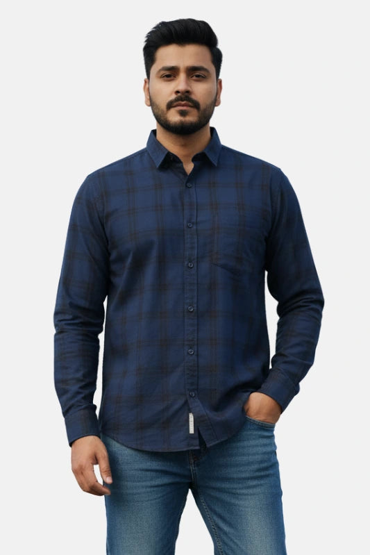 Man wearing a blue checkered shirt against a plain background - Men’s Royal Blue Check Shirt - Royal Outfits - Check Shirts - Men’s Royal Blue Check Shirt - Royal Outfits