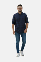 Man wearing a navy blue shirt and jeans on a plain background - Men’s Royal Blue Check Shirt - Royal Outfits - Check Shirts - Men’s Royal Blue Check Shirt - Royal Outfits