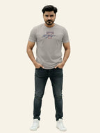 Man wearing a gray t-shirt with a logo and dark jeans on a white background Light Grey T Hedges T-Shirt Royal Outfits Printed T Shirts