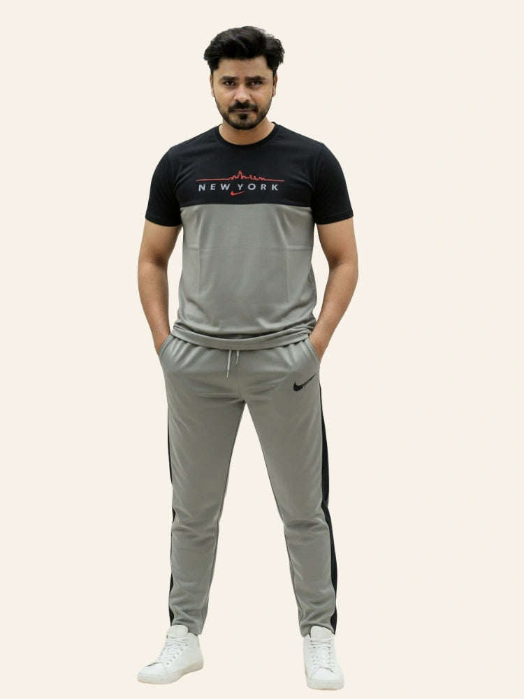 Man wearing a black and gray tracksuit with 'New York' text on a beige background Light Grey ‘New York’ Tracksuit Royal Outfits Track Suits