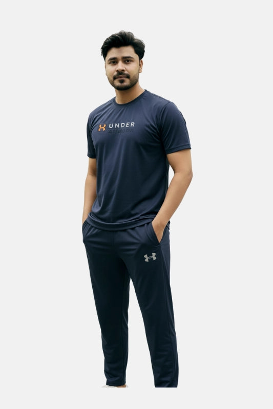 Man wearing a navy Under Armour t-shirt and pants on a white background Navy Blue ‘Under Armour’ Tracksuit Royal Outfits Track Suits - Navy Blue ‘Under Armour’ Tracksuit - Royal Outfits - Track Suits