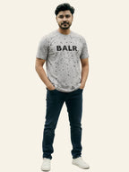 Man wearing a gray t-shirt with 'BALR.' logo and dark jeans on a white background Light Grey ‘BALR’ T-Shirt Royal Outfits Graphic T Shirts