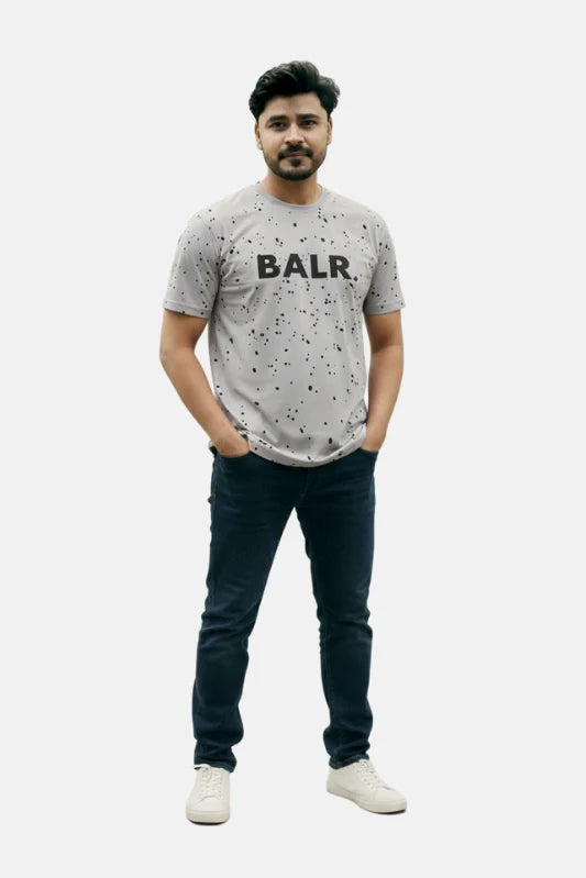 Man wearing a gray t-shirt with 'BALR.' logo and dark jeans on a white background Light Grey ‘BALR’ T-Shirt Royal Outfits Graphic T Shirts - Light Grey ‘BALR’ T-Shirt - Royal Outfits - Graphic T Shirts - Light Grey ‘BALR’ T-Shirt - Royal Outfits