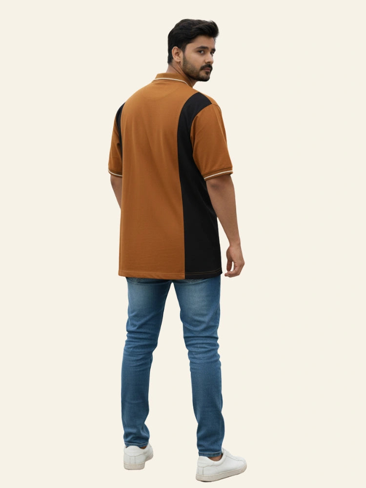 Man wearing a brown and black polo shirt with blue jeans on a beige background