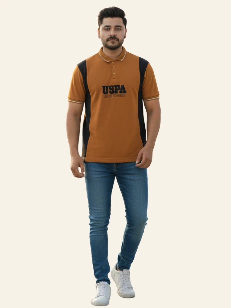 Man wearing a brown and black polo shirt with 'USPA' branding on a white background