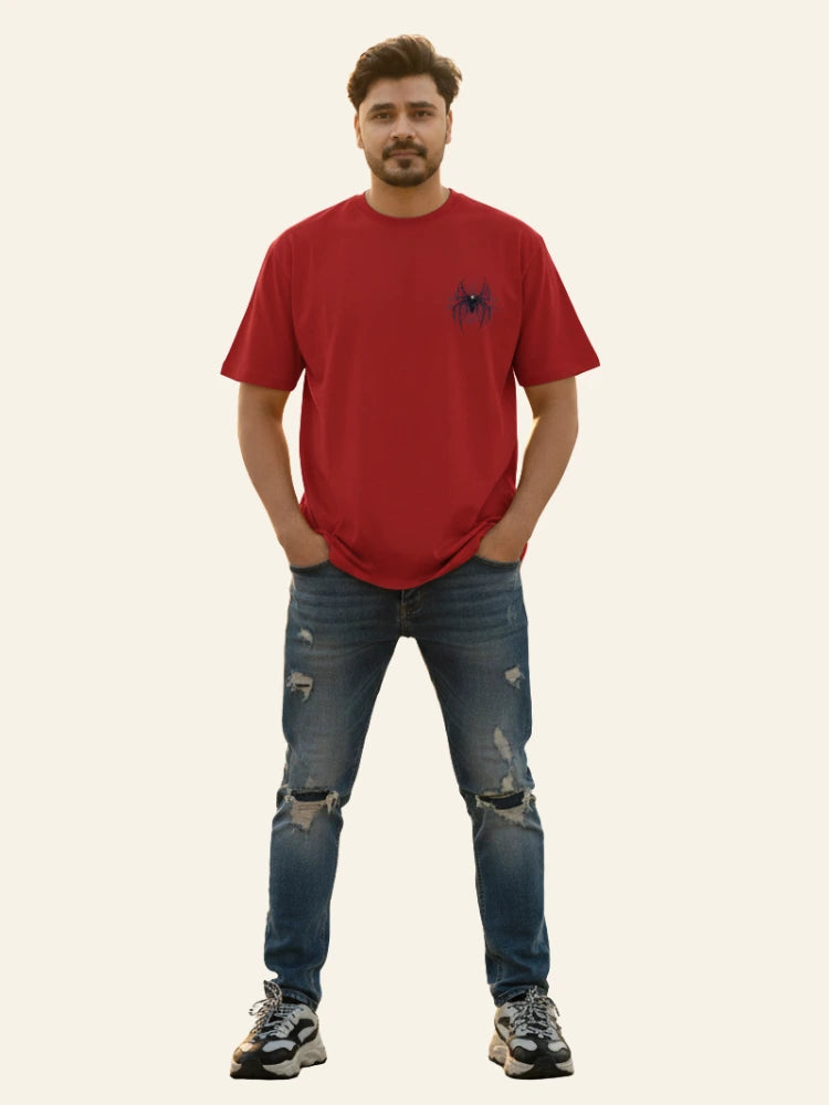 Man wearing a red t-shirt and blue jeans on a plain background Graphic Red Drop Shoulder Spider T-Shirt Royal Outfits Drop Shoulder T-Shirts