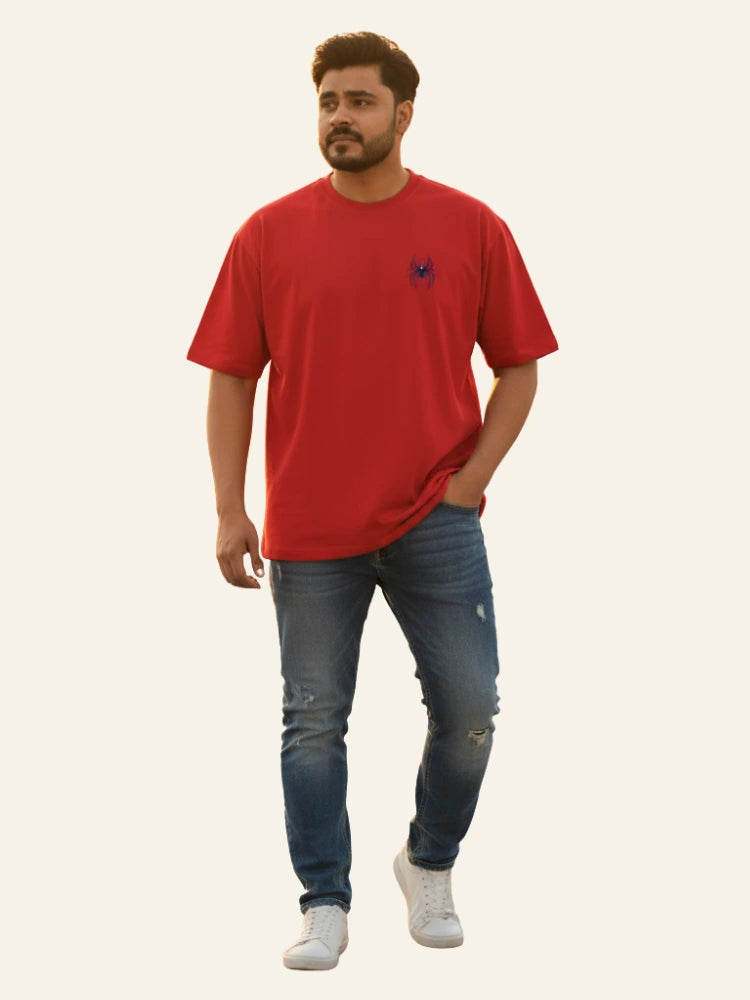 Man wearing a red t-shirt and blue jeans on a plain background Graphic Red Drop Shoulder Spider T-Shirt Royal Outfits Drop Shoulder T-Shirts