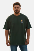Man wearing a green t-shirt with a logo on a plain background Graphic Green Drop Shoulder Feather T-Shirt Royal Outfits Drop Shoulder T-Shirts