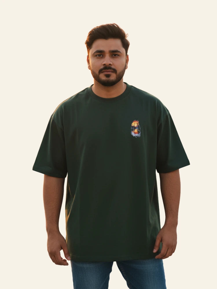Man wearing a green t-shirt with a logo on a plain background Graphic Green Drop Shoulder Feather T-Shirt Royal Outfits Drop Shoulder T-Shirts