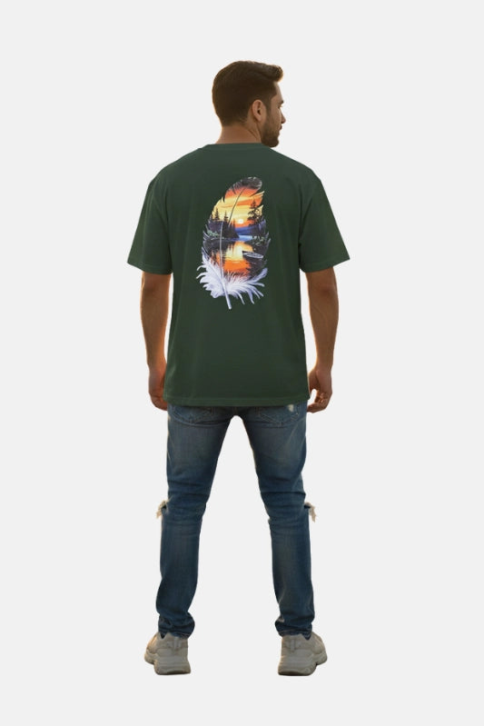 Man wearing a green t-shirt with a nature-themed design on the back, standing against a white background. Graphic Green Drop Shoulder Feather T-Shirt Royal Outfits Drop Shoulder T-Shirts - Graphic Green Drop Shoulder Feather T-Shirt - Royal Outfits - Drop Shoulder T-Shirts