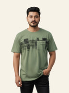 Man wearing a green t-shirt with black text design on a beige background