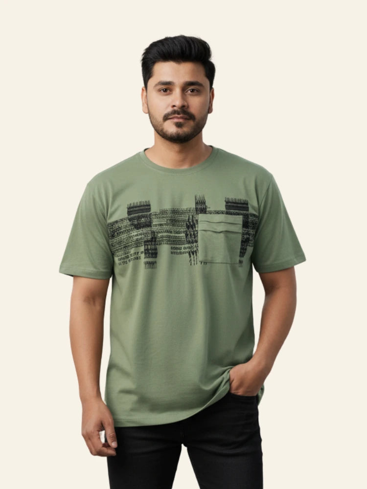 Man wearing a green t-shirt with black text design on a beige background