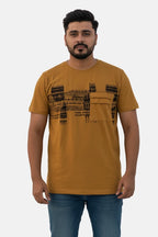 Man wearing a mustard t-shirt with black text design on a beige background - Graphic Mustard Colour T-Shirt with Chest Pocket - Royal Outfits - Printed T Shirts - Graphic Mustard Colour T-Shirt with Chest Pocket - Royal Outfits