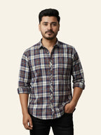 Man wearing a plaid shirt against a plain background