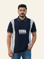Man wearing a navy blue polo shirt with 'USPA' branding on a beige background