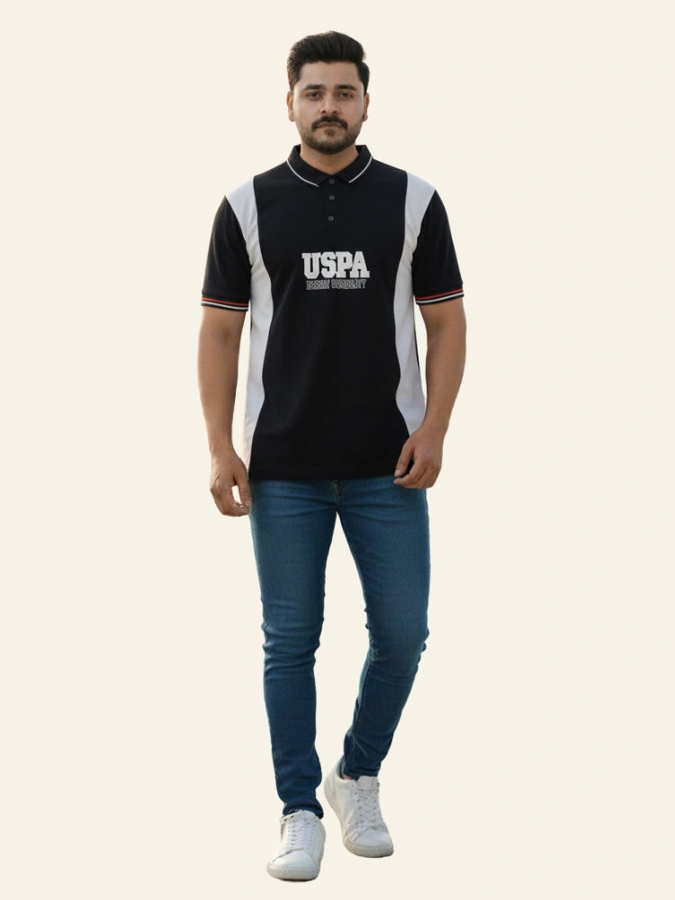 Man wearing a black and white polo shirt with 'USPA' branding on a white background