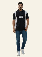 Man wearing a black and white polo shirt with 'USPA' branding on a white background