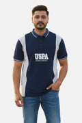 Man wearing a navy blue polo shirt with 'USPA' logo on a light background