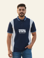 Man wearing a navy blue polo shirt with 'USPA' logo on a light background