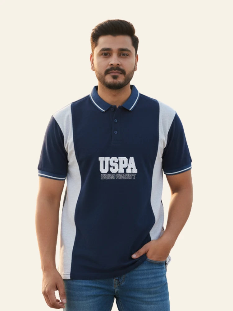 Man wearing a navy blue polo shirt with 'USPA' logo on a light background