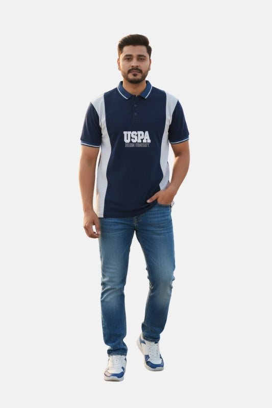 Man wearing a navy blue polo shirt with 'USPA' logo and blue jeans on a white background - Men’s Navy Blue USPA Contrast Panel Polo T-Shirt - Royal Outfits - POLO T Shirts - Men’s Navy Blue USPA Contrast Panel Polo T-Shirt - Royal Outfits