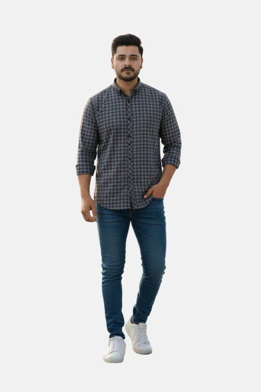 Man wearing a checkered shirt and jeans on a white background - Men’s Casual Slim Fit Plaid Shirt – Dark Grey & Black Checked Cotton Button-Up - Royal Outfits - Printed Shirts - Men’s Casual Slim Fit Plaid Shirt – Dark Grey & Black Checked Cotton Button-Up - Royal Outfits