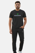 Man wearing a black 'Markhor' t-shirt and pants on a white background
