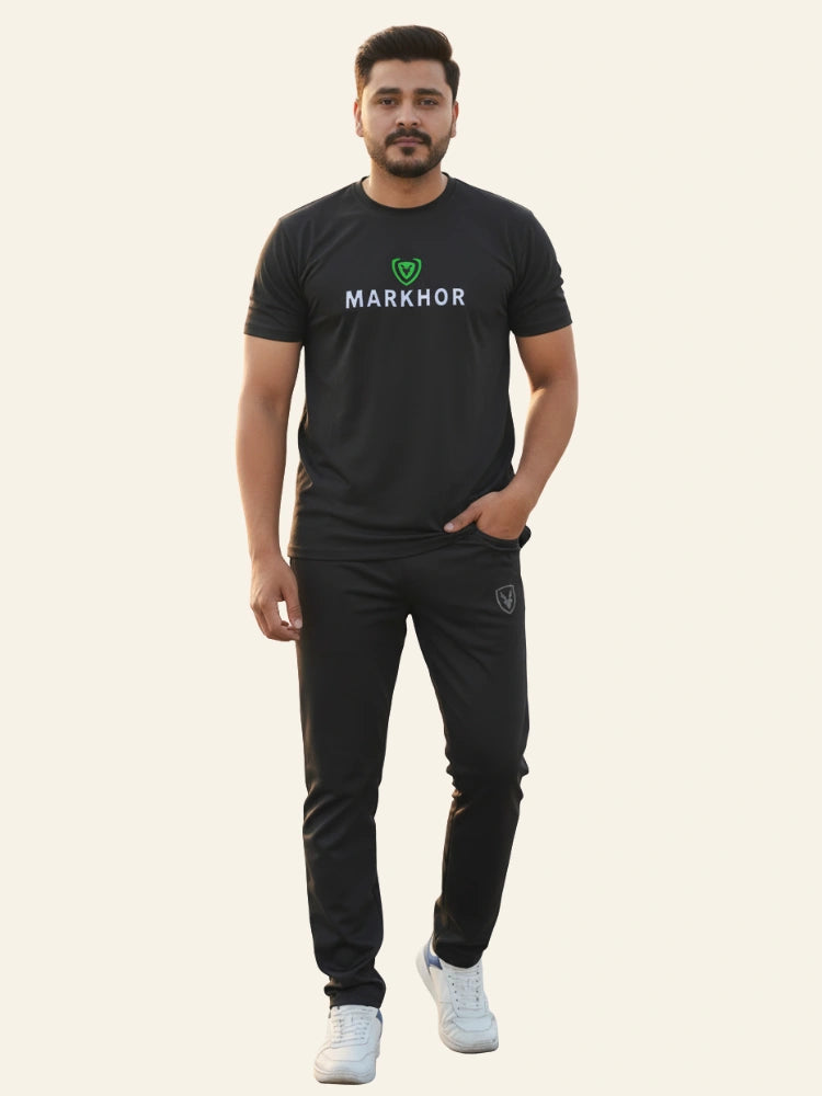 Man wearing a black 'Markhor' t-shirt and pants on a white background