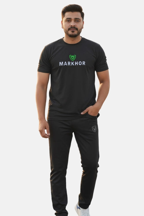 Man wearing a black 'Markhor' t-shirt and pants on a white background
