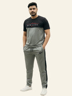 Man wearing a black and gray tracksuit with visible branding on a white background Light Grey ‘New York’ Tracksuit Royal Outfits Track Suits
