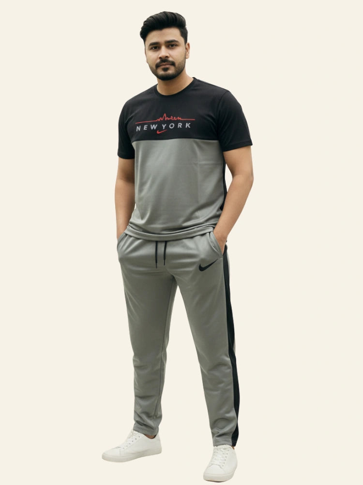 Man wearing a black and gray tracksuit with visible branding on a white background Light Grey ‘New York’ Tracksuit Royal Outfits Track Suits