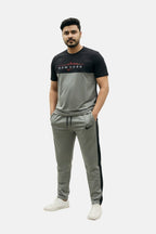 Man wearing a black and gray tracksuit with visible branding on a white background Light Grey ‘New York’ Tracksuit Royal Outfits Track Suits - Light Grey ‘New York’ Tracksuit - Royal Outfits - Track Suits