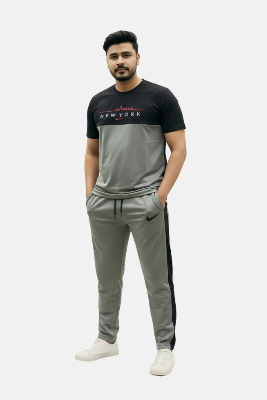 Man wearing a black and gray tracksuit with visible branding on a white background Light Grey ‘New York’ Tracksuit Royal Outfits Track Suits - Light Grey ‘New York’ Tracksuit - Royal Outfits - Track Suits