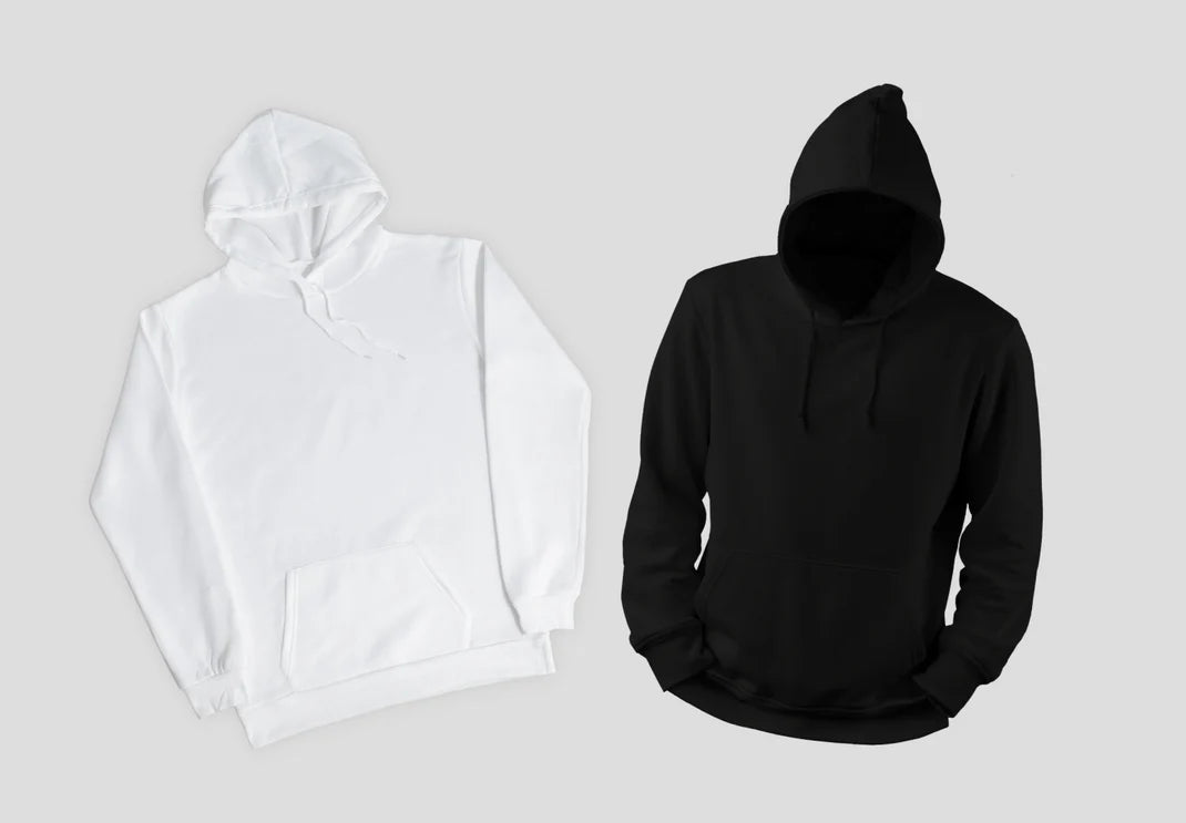White and black hoodies on a light gray background